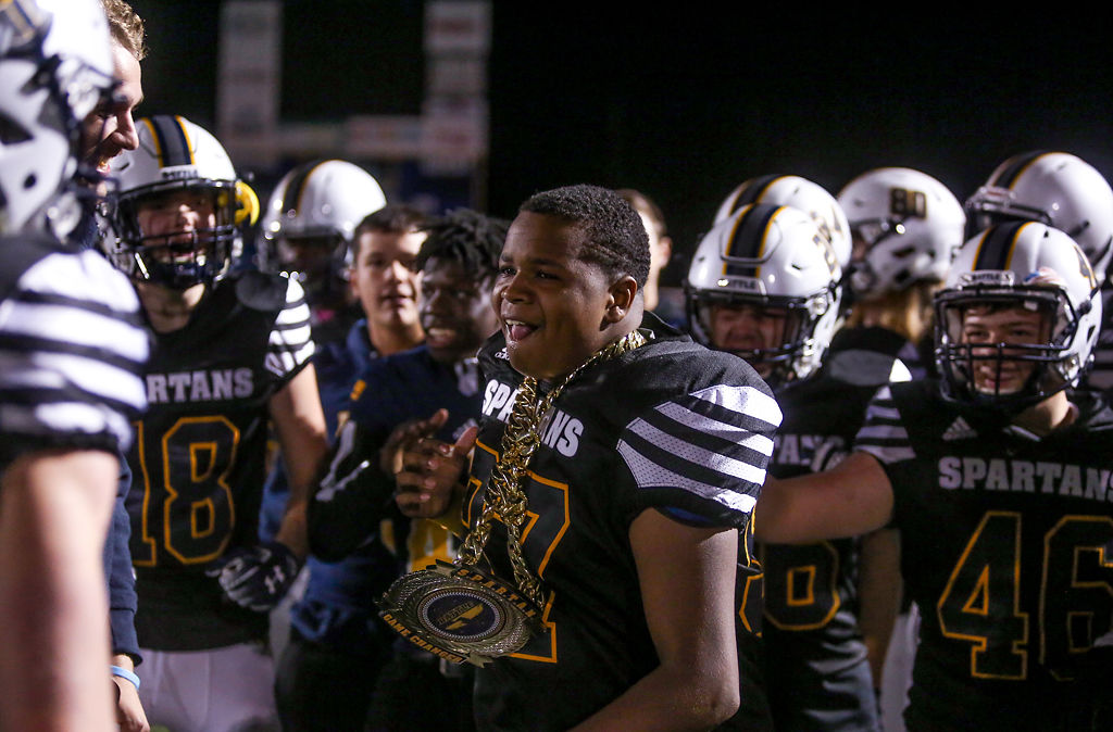 Jordan Mayes celebrates with his teammates in the end zone